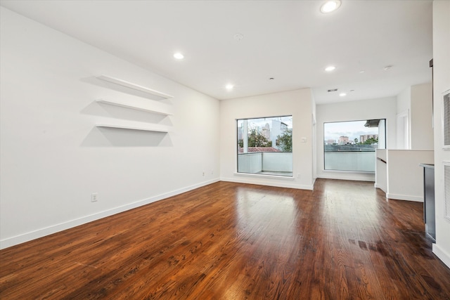 unfurnished living room with dark wood-type flooring