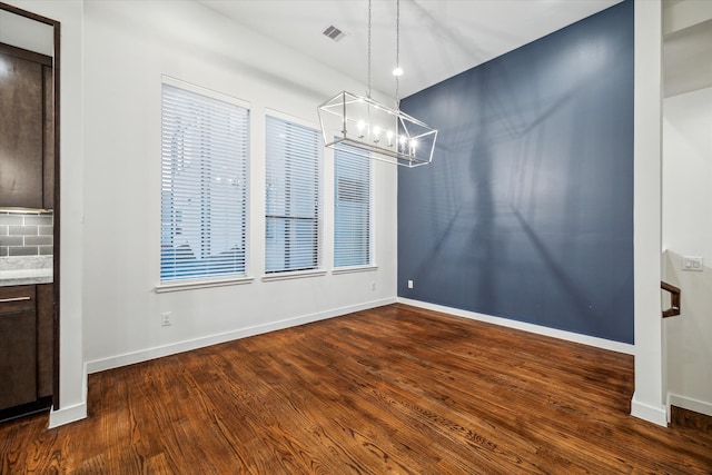 unfurnished dining area featuring dark hardwood / wood-style flooring