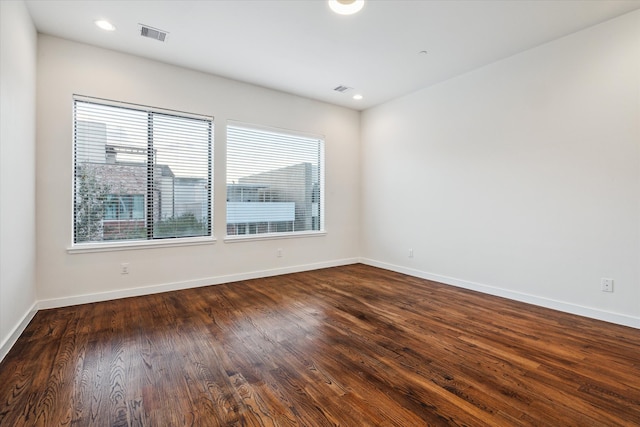 spare room with dark hardwood / wood-style floors