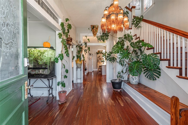 entrance foyer featuring an inviting chandelier and hardwood / wood-style floors