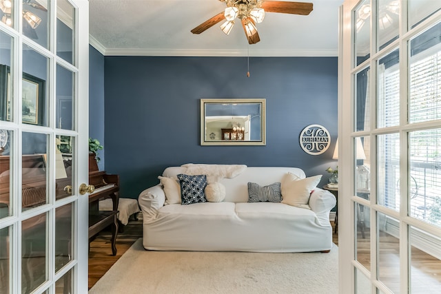 living room with ornamental molding, ceiling fan, hardwood / wood-style flooring, and plenty of natural light