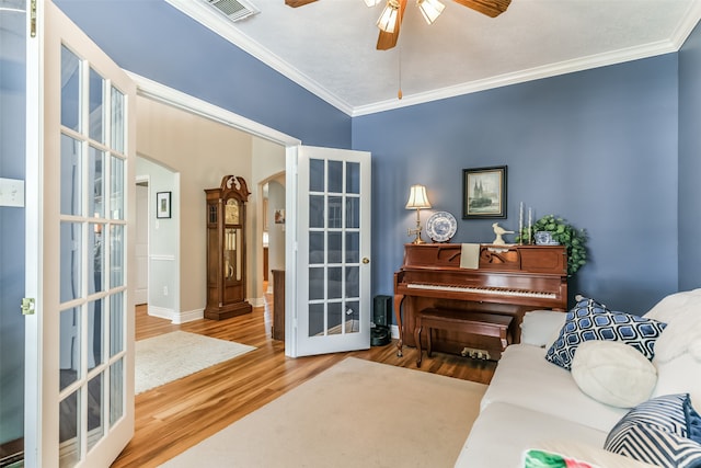 living area with french doors, hardwood / wood-style flooring, and ceiling fan