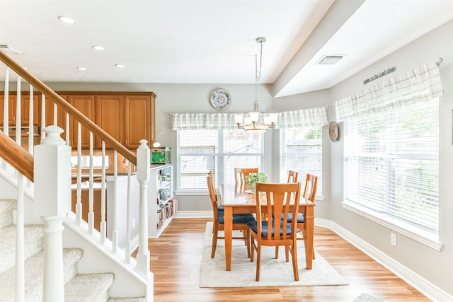 dining room featuring light hardwood / wood-style floors and a chandelier