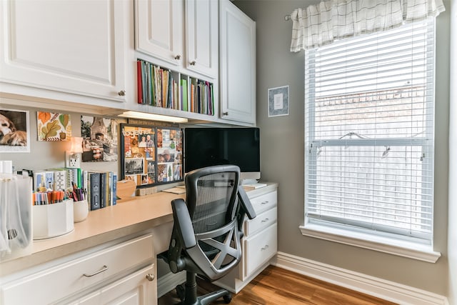 office area featuring built in desk and light wood-type flooring