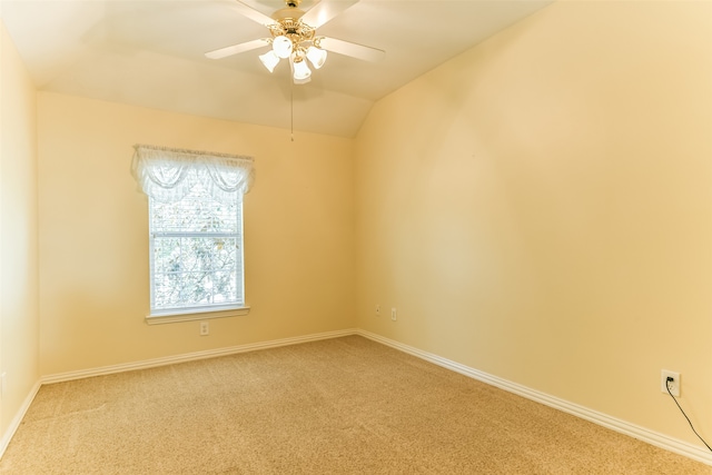 carpeted empty room featuring vaulted ceiling and ceiling fan