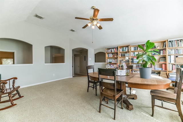 dining room with carpet floors, ceiling fan, and vaulted ceiling