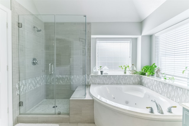 bathroom featuring vaulted ceiling and plus walk in shower