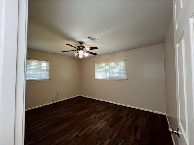 unfurnished room featuring ceiling fan and dark hardwood / wood-style flooring