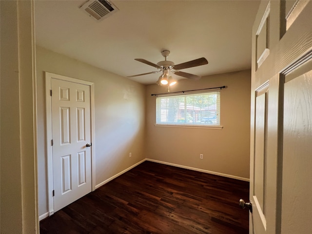 unfurnished bedroom featuring dark wood-type flooring and ceiling fan