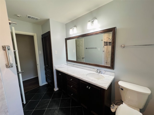 bathroom featuring vanity, toilet, and tile patterned floors