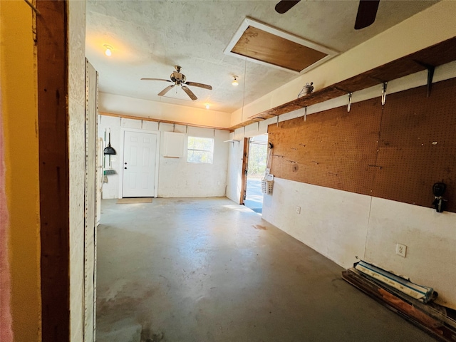 interior space with ceiling fan