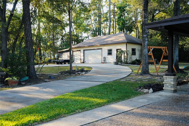 view of front of property featuring a garage and a front lawn