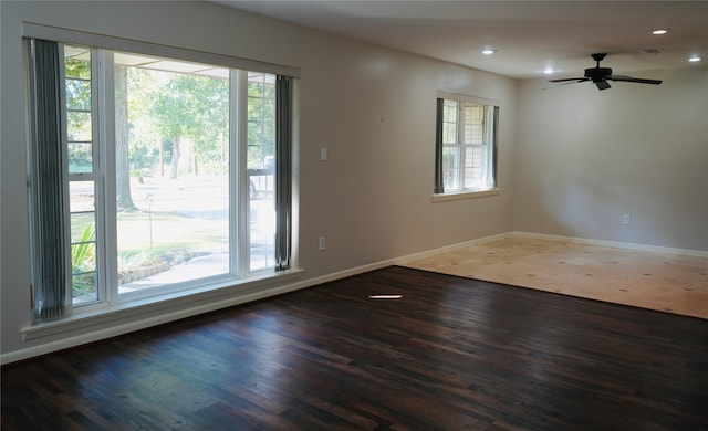 unfurnished room featuring dark hardwood / wood-style floors and ceiling fan