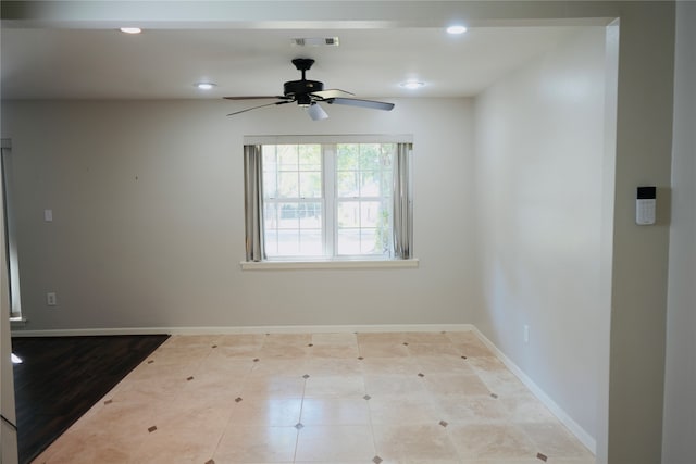 spare room featuring light hardwood / wood-style floors and ceiling fan