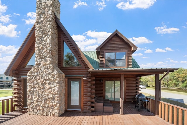 rear view of property with a wooden deck