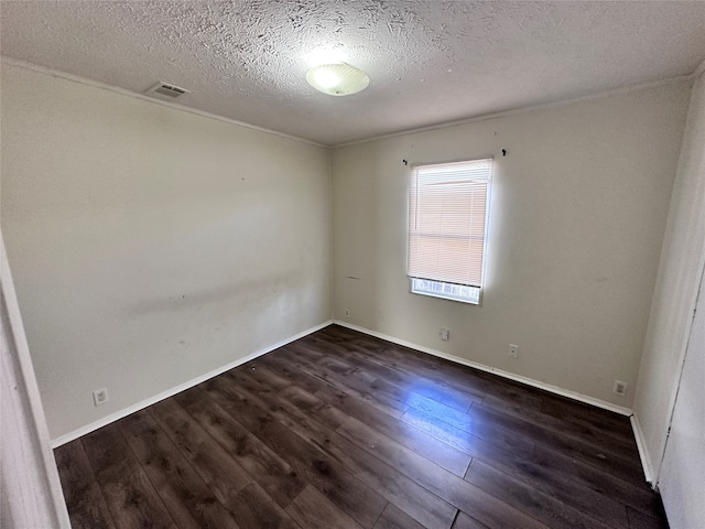 spare room with dark hardwood / wood-style floors and a textured ceiling