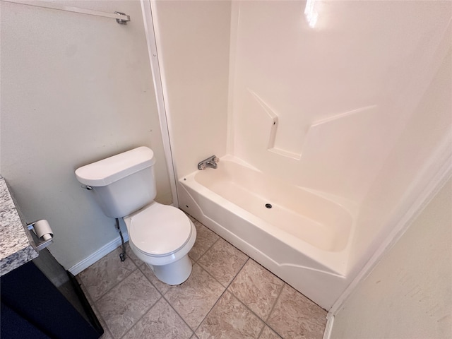 bathroom with toilet and tile patterned flooring