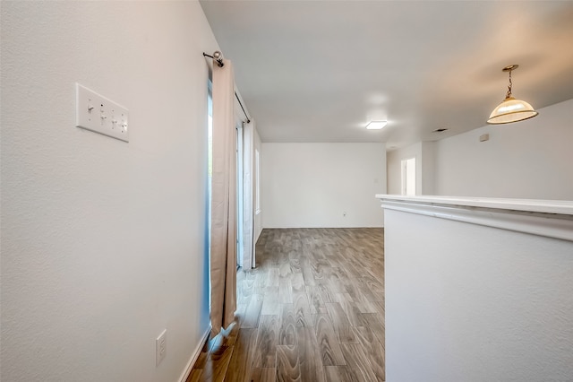 hall with hardwood / wood-style flooring