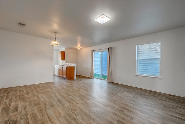 unfurnished living room featuring light hardwood / wood-style flooring