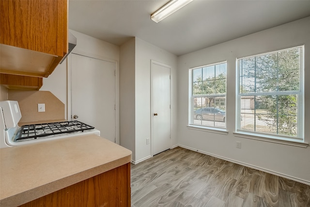 kitchen featuring light hardwood / wood-style floors and white range