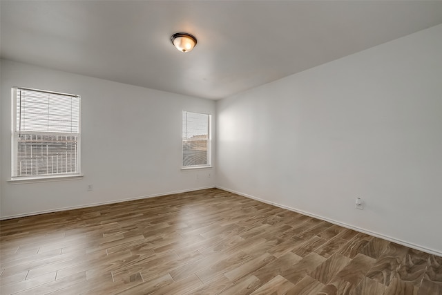 unfurnished room with light hardwood / wood-style floors