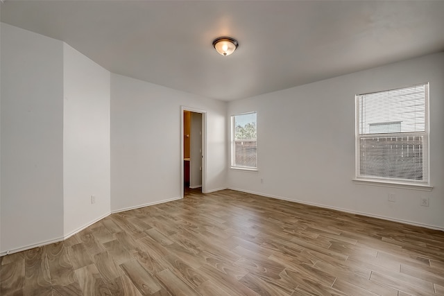 spare room with light hardwood / wood-style flooring