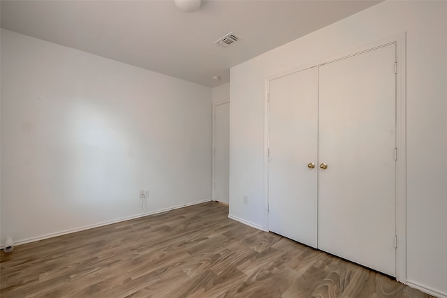 unfurnished bedroom with hardwood / wood-style floors