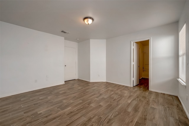 spare room featuring wood-type flooring