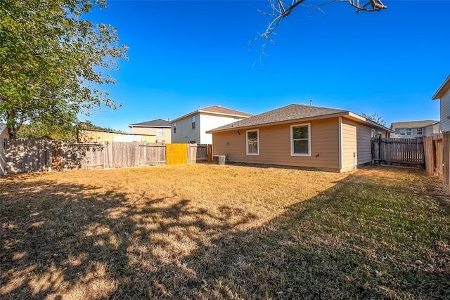 rear view of property with a lawn