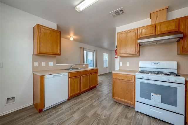 kitchen featuring kitchen peninsula, sink, light wood-type flooring, and white appliances