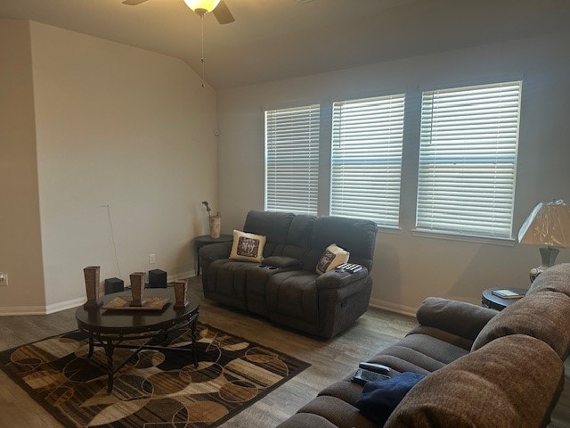 living room with lofted ceiling, light wood-type flooring, and ceiling fan