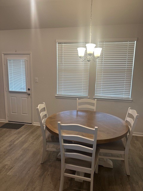 dining room with a notable chandelier and dark hardwood / wood-style floors