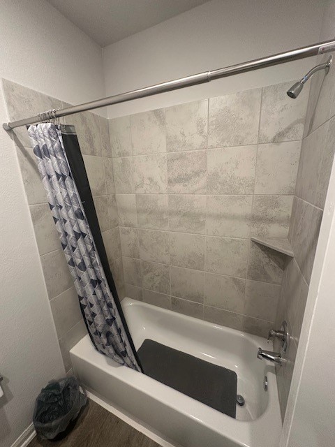 bathroom featuring shower / bath combo with shower curtain and hardwood / wood-style floors