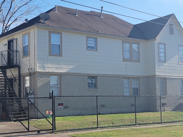 view of side of home featuring a lawn