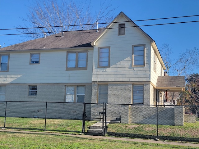 rear view of house with a lawn