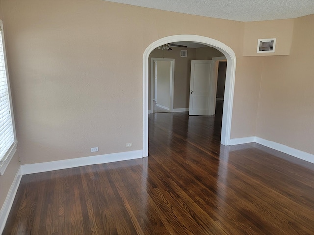 2601 Wheeler St, Houston, TX 77004 - unfurnished room featuring arched walkways, dark wood-style flooring, and baseboards