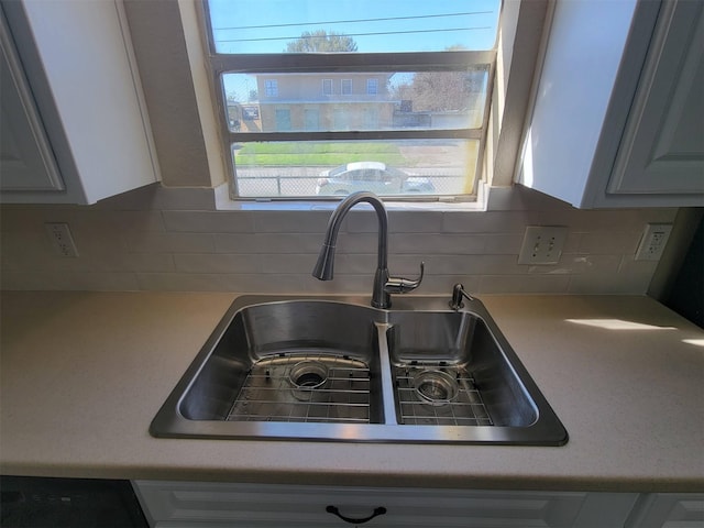 2601 Wheeler St, Houston, TX 77004 - kitchen view of a sink, light countertops, tasteful backsplash, and white cabinets