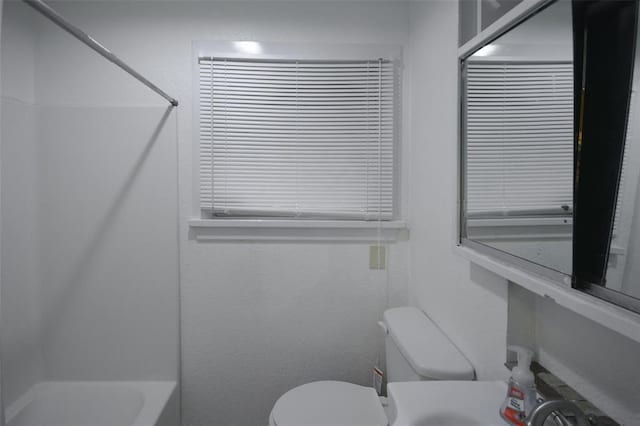 bathroom featuring toilet and shower / bathing tub combination