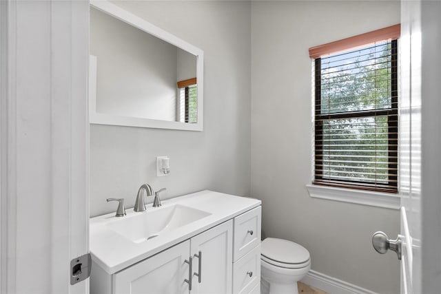 bathroom featuring toilet and vanity