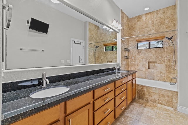 bathroom with vanity and tiled shower / bath