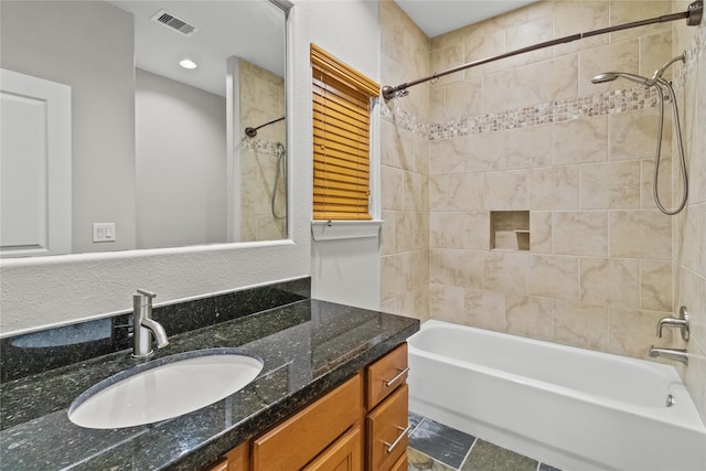 bathroom featuring vanity and tiled shower / bath combo