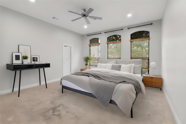 bedroom with ceiling fan, multiple windows, and light colored carpet