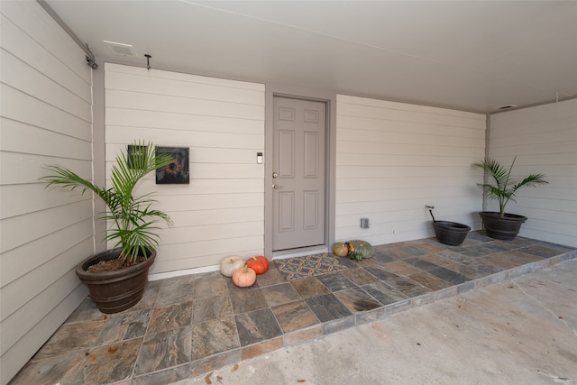 entrance to property featuring a patio