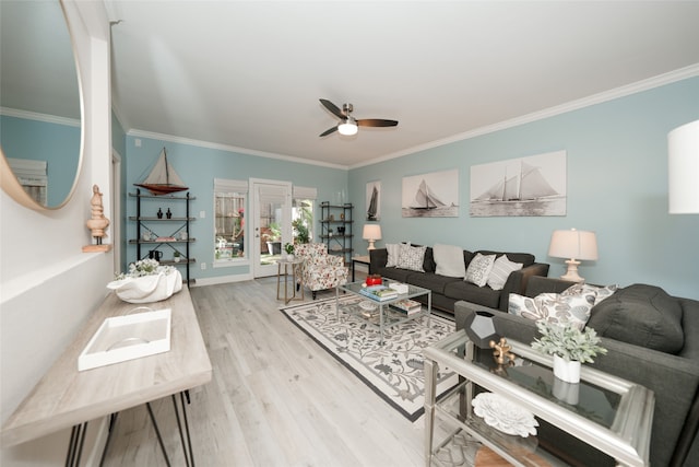 living room featuring ceiling fan, ornamental molding, and light wood-type flooring