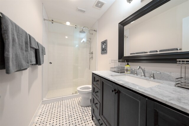 bathroom featuring vanity, toilet, and an enclosed shower