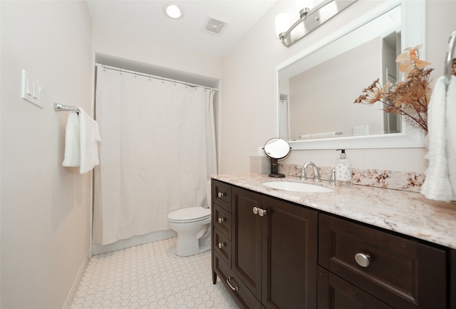 bathroom featuring vanity, a shower with shower curtain, and toilet