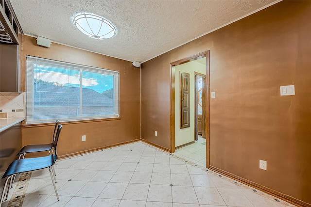 unfurnished office with built in desk and a textured ceiling