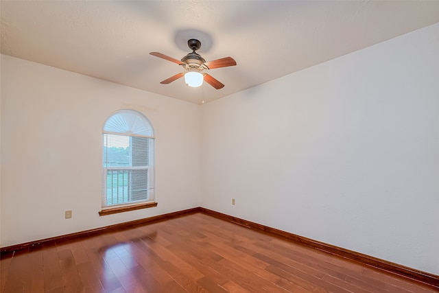 empty room featuring hardwood / wood-style floors and ceiling fan