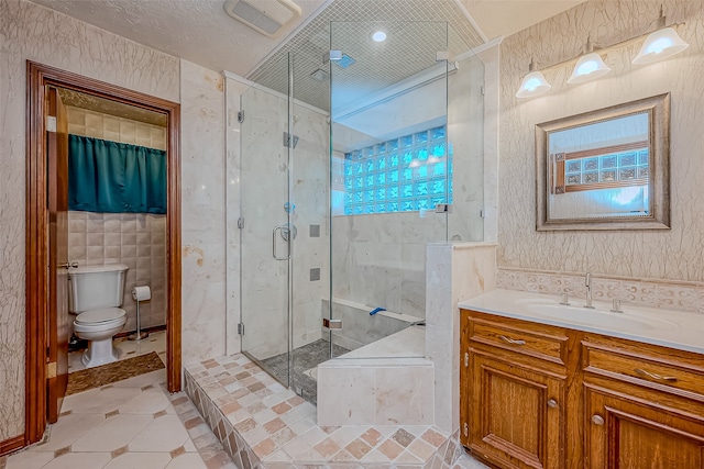 bathroom featuring a wealth of natural light, vanity, a shower with shower door, and toilet