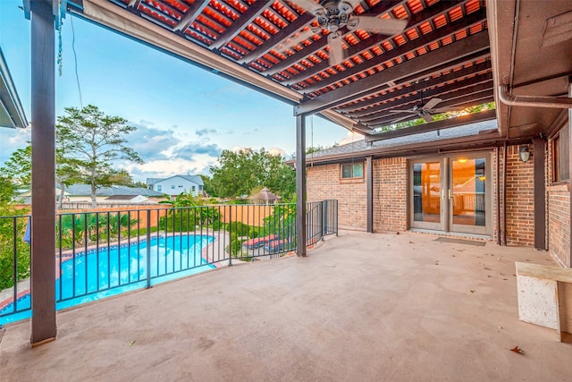 view of patio featuring a fenced in pool and ceiling fan